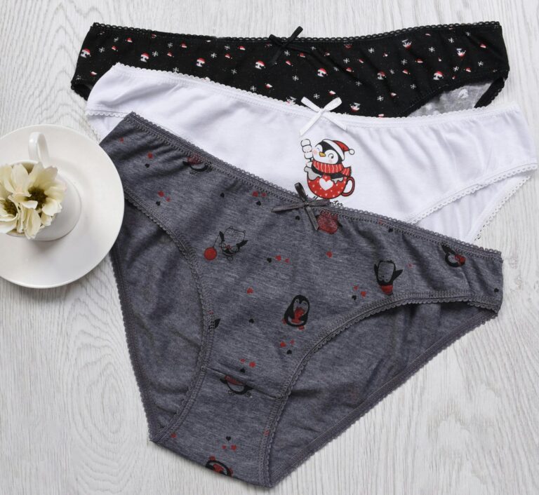 A stylish flat lay of colorful women's panties on a wooden surface, showcasing fun patterns.