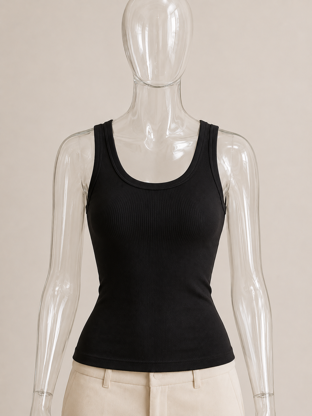 Black rib tank top by CG Claudia Garcia displayed on a transparent glass mannequin against a soft beige background.
