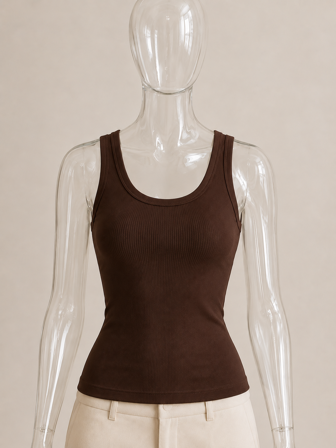Coffee brown rib tank top by CG Claudia Garcia displayed on a transparent glass mannequin against a soft beige background.