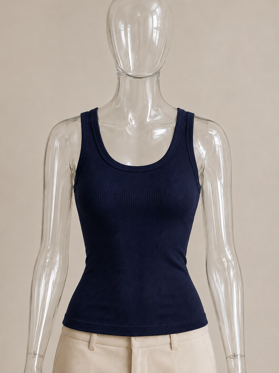 Navy rib tank top by CG Claudia Garcia displayed on a transparent glass mannequin against a soft beige background.