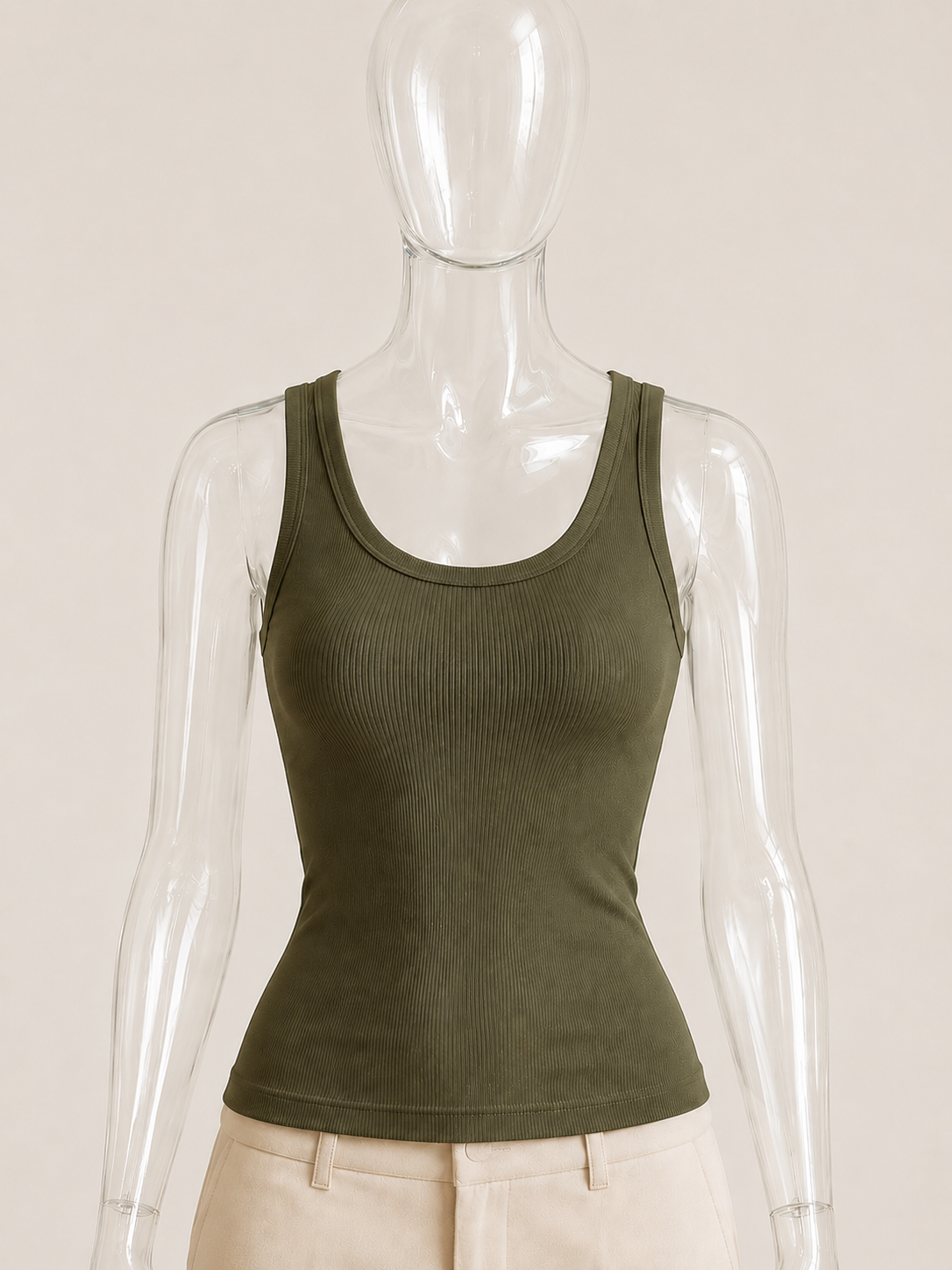 Olive green rib tank top by CG Claudia Garcia displayed on a transparent glass mannequin against a soft beige background.