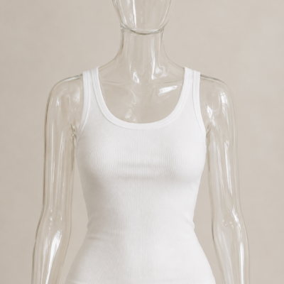 White rib tank top by CG Claudia Garcia is displayed on a transparent glass mannequin against a soft beige background.